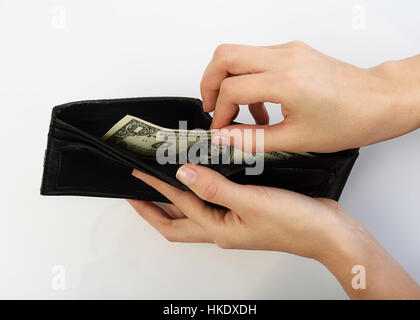 Person taking one dollars bill money from black wallet Stock Photo