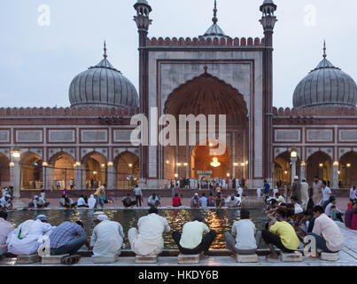 Delhi, India - August 2 2014:  Muslim men clean their feet before entering the famous Jama Mosque in Old Delhi in India capital city. Stock Photo