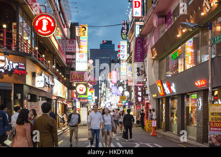 SEOUL, SOUTH KOREA - SEPTEMBER 12 2015: People wander in the walking streets of the Myeong-dong shopping district at night. Stock Photo