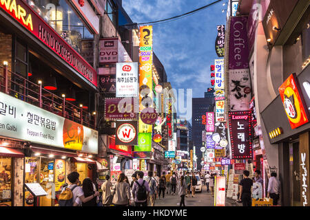 SEOUL, SOUTH KOREA - SEPTEMBER 12 2015: People wander in the walking streets of the Myeong-dong shopping district at night. Stock Photo