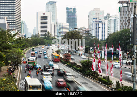 JAKARTA, INDONESIA - AUGUST 19, 2015: Traffic, captured with blurred motion, rushes through the modern business district of Jakarta in Indonesia capit Stock Photo