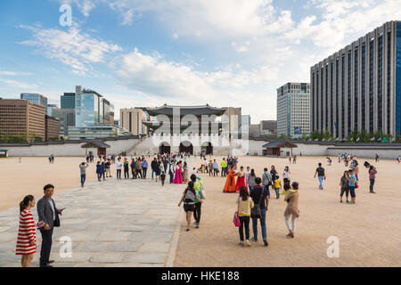 SEOUL, SOUTH KOREA - SEPTEMBER 12 2015: Tourists visit the Gyeongbokgung palace those traditional architecture contrast with the modern building outsi Stock Photo