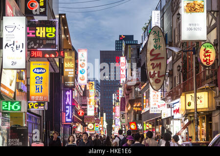 SEOUL, SOUTH KOREA - SEPTEMBER 12 2015: People wander in the walking streets of the Myeong-dong shopping district at night. Stock Photo