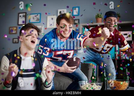 Man in sports clothing round falling confetti Stock Photo