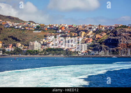 Sailing away from the colourful homes of San Sebastian town in La Gomera, Canary Islands, Spain Stock Photo