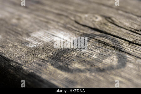Black heart painted on a wooden table. Extreme close up. Defocused blurry background. Stock Photo