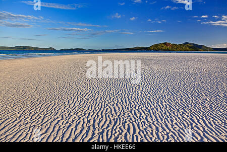 Random light-shade pattern on white silica sandy Whitehaven beach of Whitsundays island formed in wind work traces of soft soil. Stock Photo