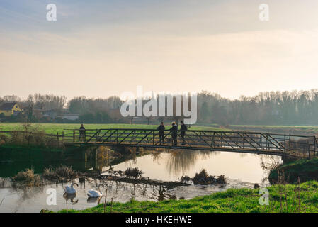 Sudbury Suffolk, people chat on a bridge over the River Stour in the water meadows at Sudbury in Suffolk, Babergh district, UK. Stock Photo