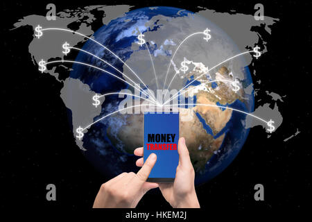 Hand holding smart phone sent money dollar bills flying away from screen to global map. Technology online banking money transfer, e-commerce concept. Stock Photo