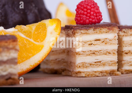 Very tasty chocolate cake  with orange on a wooden base, selective focus and small depth of field Stock Photo