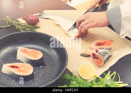 seafood - chef slicing salmon fish for preparing Stock Photo