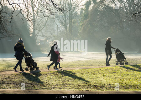 The school run - mums walking their children to school on a frosty morning in Barnes, south west London, England, U.K. Stock Photo