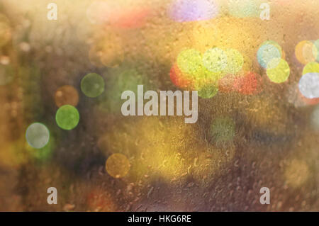 Big city lights behind the rainy window Stock Photo