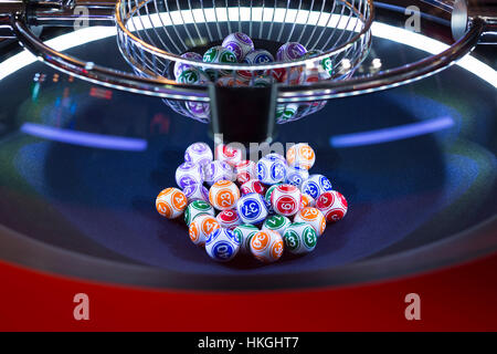 Colourful lottery balls in a rotating bingo machine. Stock Photo