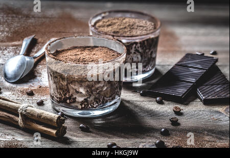 Traditional coffee and chocolate dessert decorated with cocoa on a rustic wooden table. Stock Photo