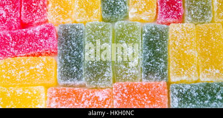 Jelly sweets in a row forming background Stock Photo