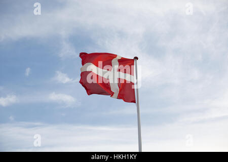 fluttering danish flag and cloudy sky. flagpole, patriotism, national flag, denmark.