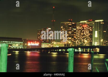 At night, a neon sign is visible on the headquarters building of the Miami Herald newspaper at One Herald Plaza, with the Miami Marriott hotel also visible, Miami, Florida, 1987 Stock Photo