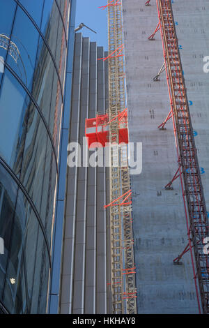 Office construction work, City of London financial district. Showing external works / material lift on buildings core lift shaft /lift tower. Stock Photo