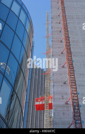 Office construction work, City of London financial district. Showing external works / material lift on buildings core lift shaft /lift tower. Stock Photo