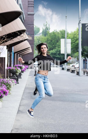 Jumping woman in the city Stock Photo