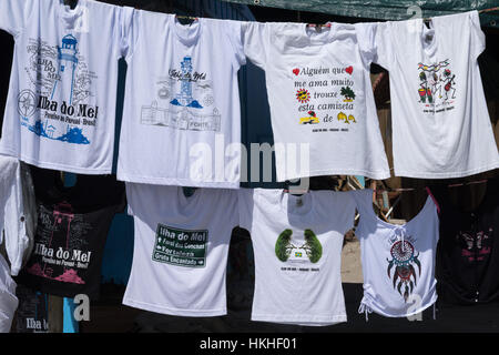 T-shirts with island design and emblem displayed in a small shop along the beach, Ilha do Mel, Paraná, Brazil, South America Stock Photo