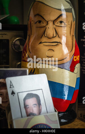 Communist symbols and items. Gorbachev button, Saddam Hussein playing identity cards and Matryoshka Nesting Dolls, Boris Yeltsin. Stock Photo