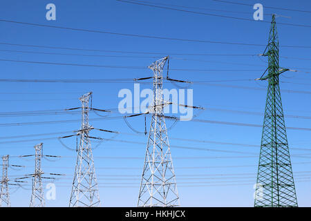 High voltage towers, under the blue sky white clouds at february Stock ...