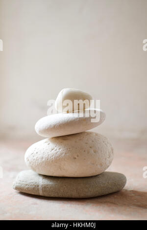 A stack of pebbles with white tones against a rustic background Stock Photo