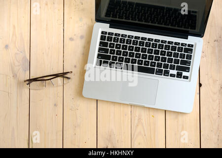 Wooden desk with various gadgets and accessories Stock Photo