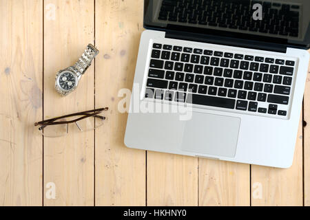 Wooden desk with various gadgets and accessories Stock Photo