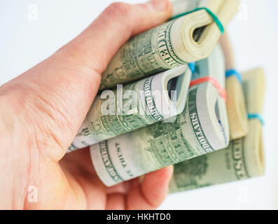 Hand holds a lot of packs with dollar bills Stock Photo