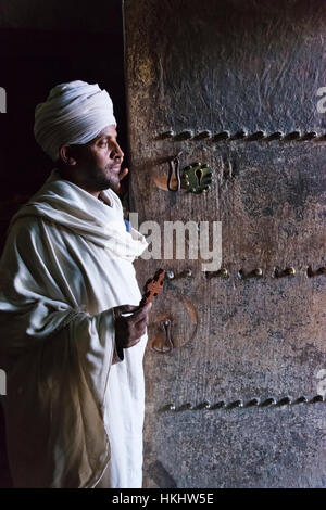 Priest in Yemrehanna Kristos Church, built inside a natural cavern, Lalibela, Ethiopia Stock Photo