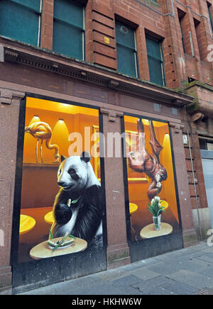 Panda  and monkey eating, drawn on shop front, Queen Street, Glasgow, Scotland, UK, G1 3EF Stock Photo