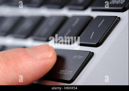 enter button press on laptop close up Stock Photo