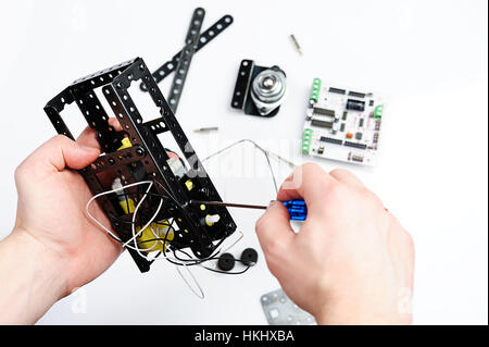 Making robot body with screw on white Stock Photo