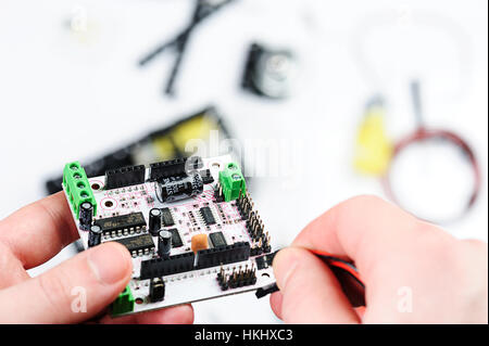 Connect wire to electronic board on white Stock Photo