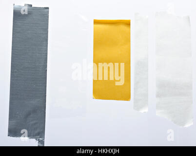 sticky cut tape pieces isolated on white background Stock Photo