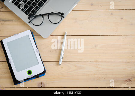 Wooden desk with various gadgets and accessories Stock Photo