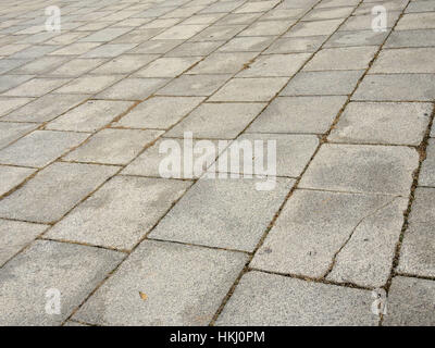 Patterned paving stone. Granite cobble stoned pavement background Stock Photo