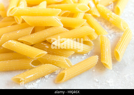 Assorted italian Raw Uncooked Pasta on white background with copy space for text Stock Photo