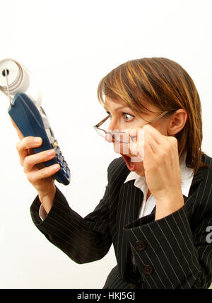 Young, shocked business woman with pocket calculator Stock Photo