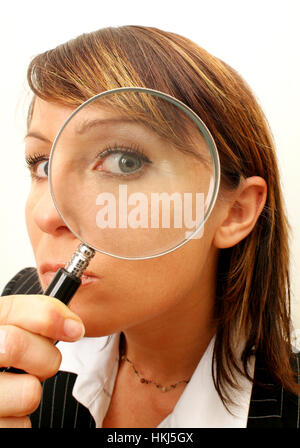 Business woman looking through a loupe Stock Photo