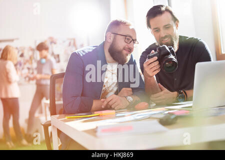 Photographer design professionals with SLR camera in office Stock Photo