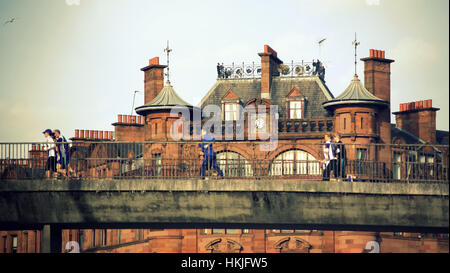 people on the pedestrian bridge at  St. George’s Mansions at charing cross and sauchiehall street Glasgow Stock Photo