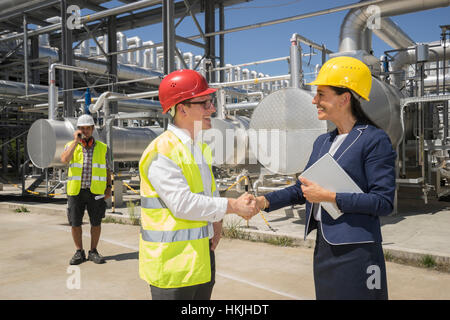 businessman and engineer shaking hands at geothermal power station, Bavaria, Germany Stock Photo