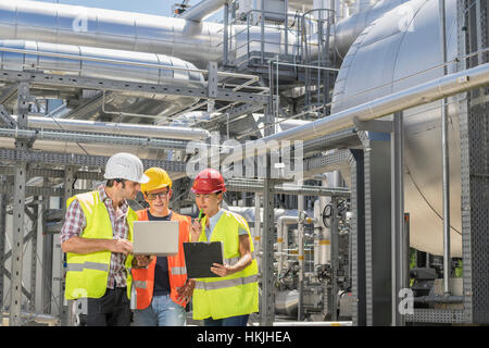 Engineer with his colleagues in meeting with laptop at geothermal power station, Bavaria, Germany Stock Photo