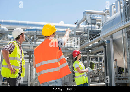 Engineer with his colleagues in meeting and showing something at geothermal power station, Bavaria, Germany Stock Photo
