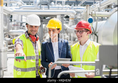 Engineer with his colleagues in meeting and showing something at geothermal power station, Bavaria, Germany Stock Photo