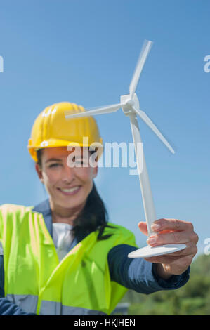 Female engineer showing wind turbine at geothermal power station, Bavaria, Germany Stock Photo